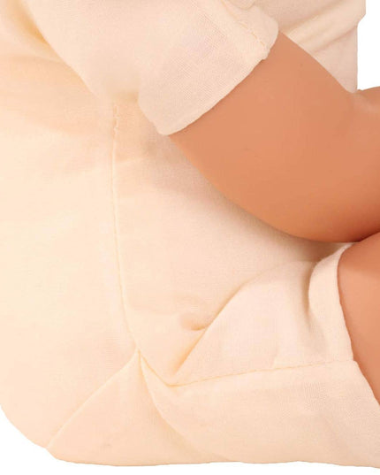 Close-up of the Gotz Catness doll underneath her clothes wearing beige pants with a white shirt on a white background