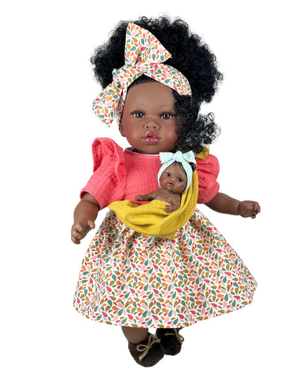 Doll with a baby in a colorful outfit on a white background