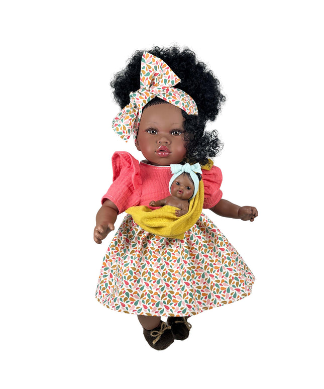 Doll with a baby in a colorful outfit on a white background