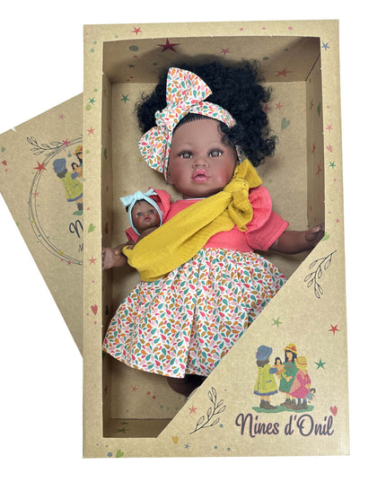 Baby doll in a decorative box with 'Nines d'Oril' branding
