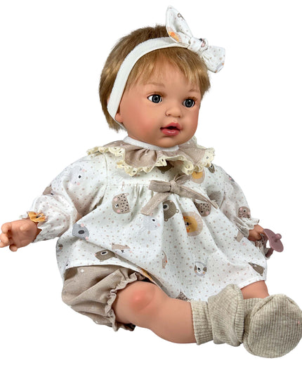 Baby doll wearing a white outfit with animal patterns on a white background