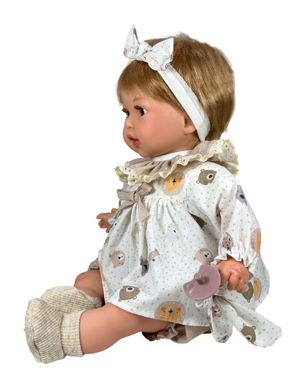 Baby doll with a white dress featuring animal prints on a white background