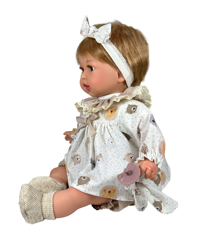 Baby doll with a white dress featuring animal prints on a white background