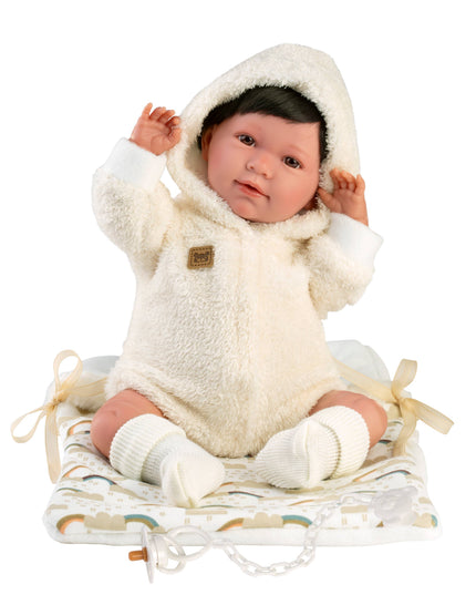 Baby doll in a white fleece outfit with a hood on a white background