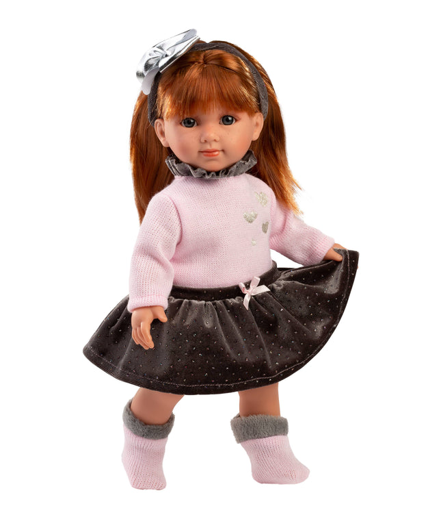 Doll wearing a pink sweater and black skirt with a white background