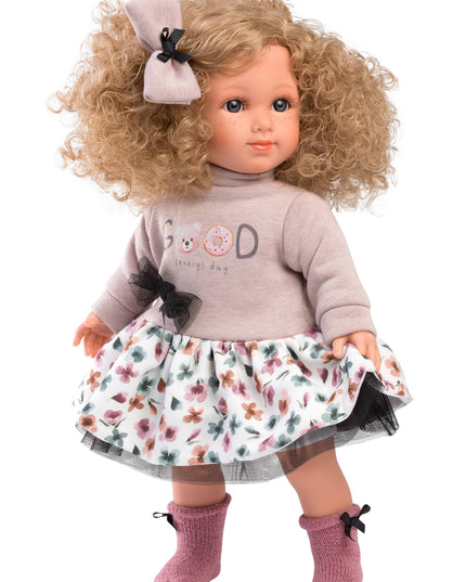 Doll with blonde hair, floral dress, and gray sweater on a white background