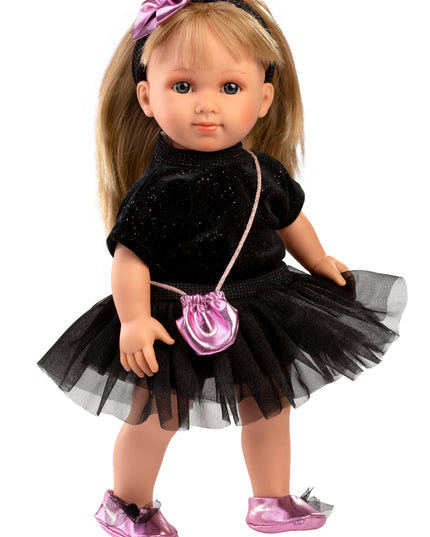 Doll wearing a black dress with a pink purse and shoes on a white background