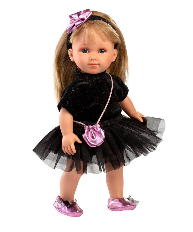 Doll wearing a black dress with a pink purse and shoes on a white background