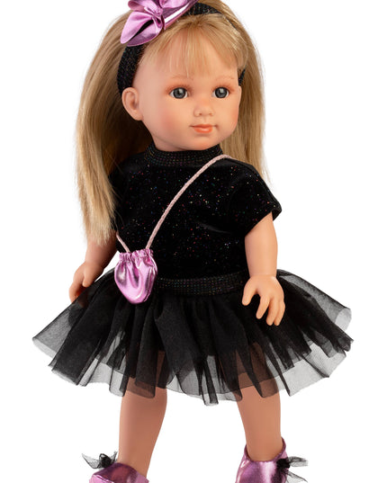 Doll wearing a black outfit with a pink bow and bag on a white background