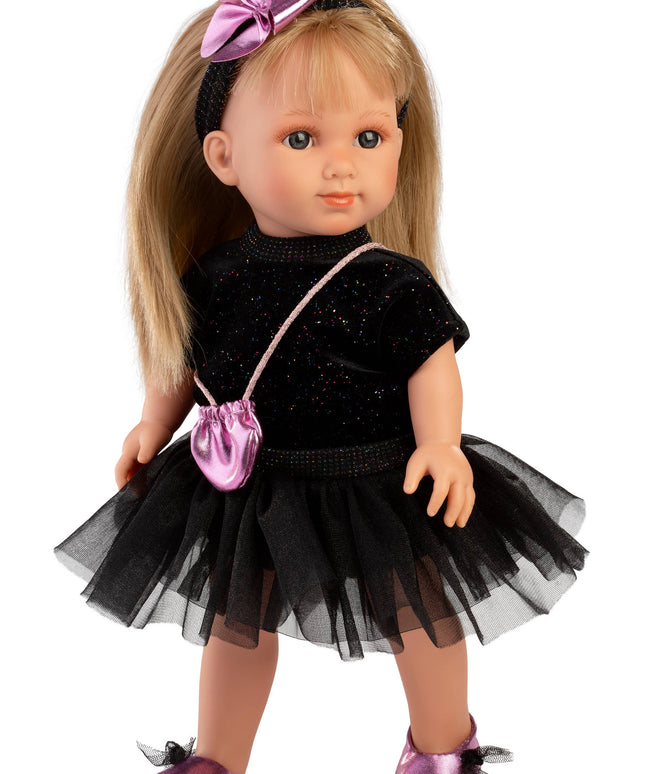 Doll wearing a black outfit with a pink bow and bag on a white background