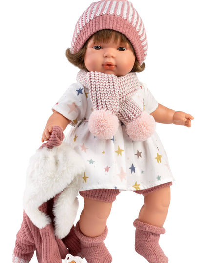 Doll wearing a pink outfit with a white background