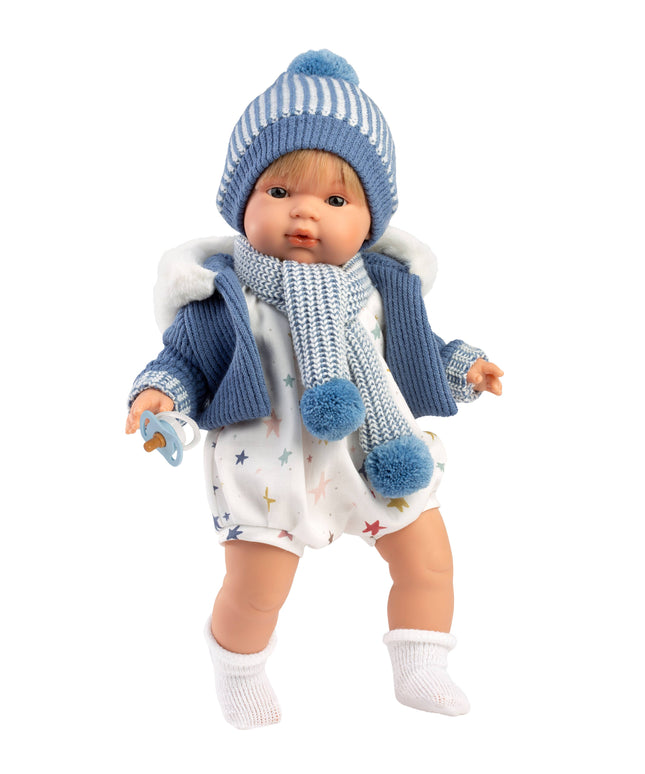 Baby doll wearing a blue outfit with a hat and scarf on a white background