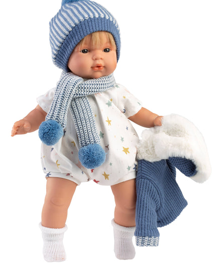 Doll wearing a blue and white outfit with a hat and scarf on a white background
