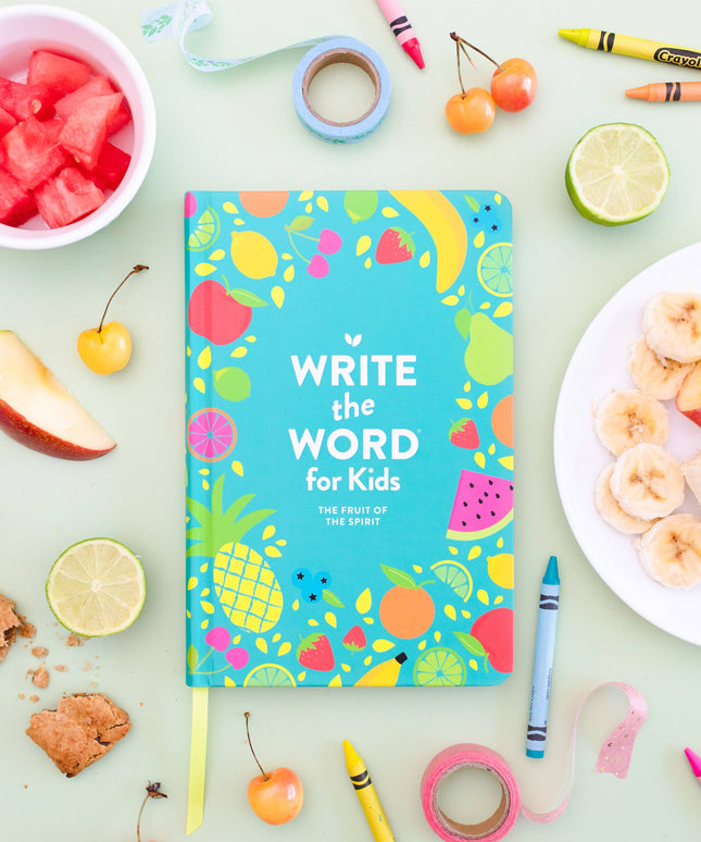 Notebook titled 'Write the Word for Kids' surrounded by fruits, crayons, and snacks on a light green background