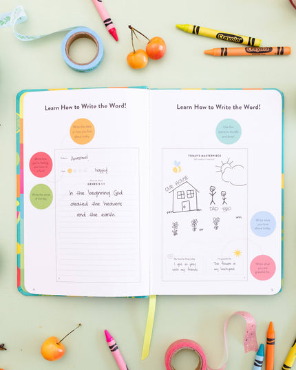 Open book on a table with educational content, surrounded by crayons, fruit, and snacks.