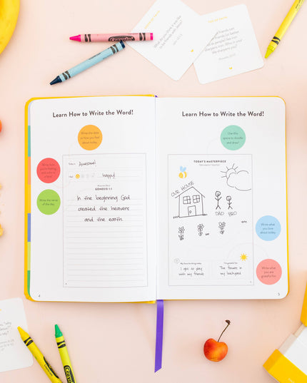 Open book with educational content on a table with crayons and snacks