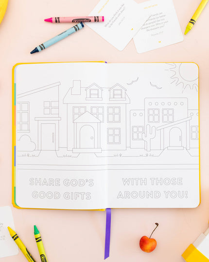 Coloring book with a house illustration and motivational text on a table with crayons and snacks.