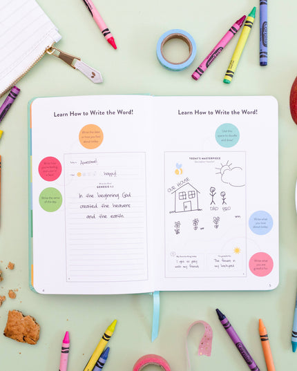 Open book with educational content on a table with crayons and snacks