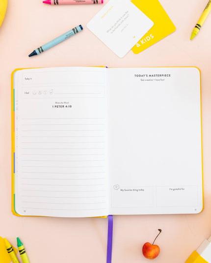 Notebook with a colorful pen and snack items on a pink background