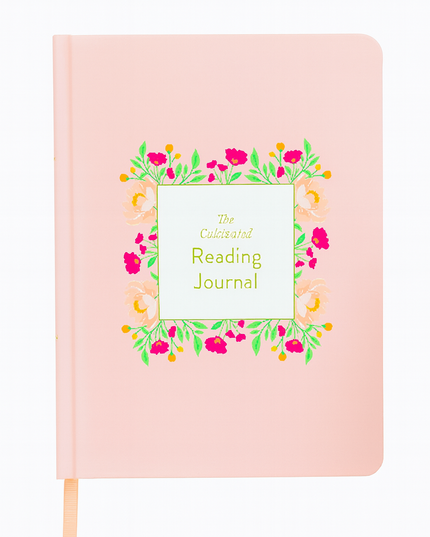 Pink reading journal with floral design and text on a white background
