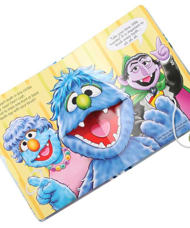 Children's book with Sesame Street characters and a toothbrush on a white background