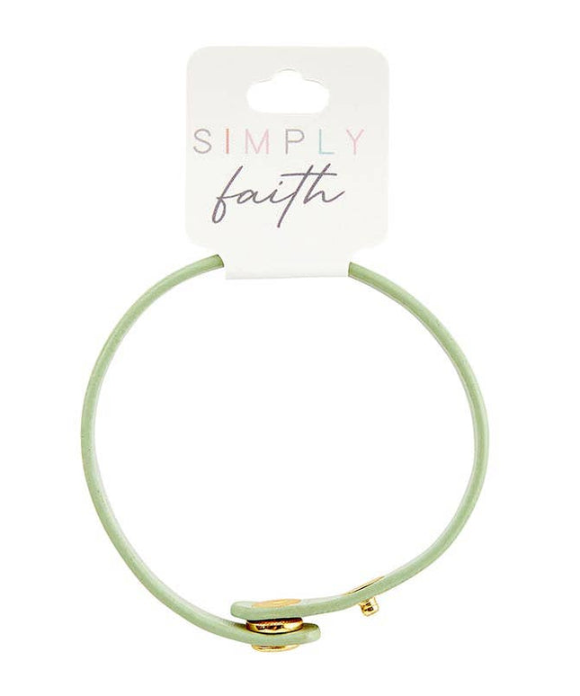 Light green hair tie with gold accent on a 'Simply Faith' branded card