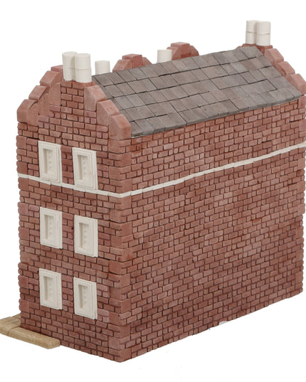 Model of a brick building with a gray roof on a white background