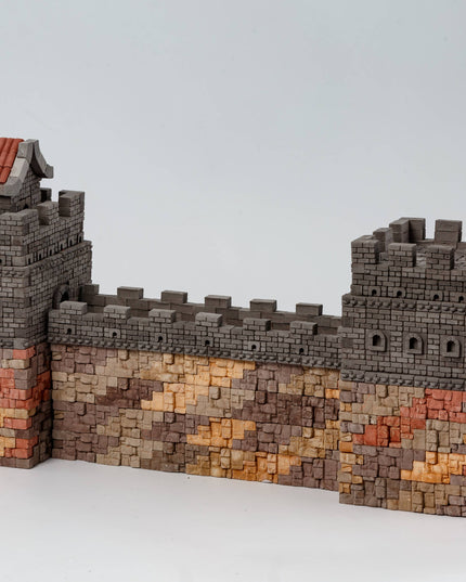 Model of a wall with towers and battlements on a white background