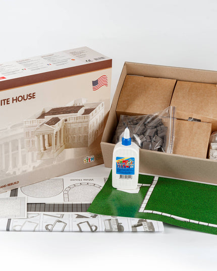 Model building kit with components and glue, featuring a box labeled 'White House'.