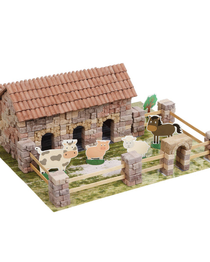 Model farm with animals and a barn on a white background