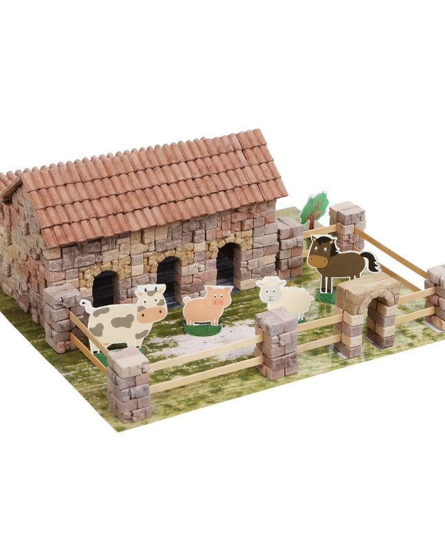 Model farm with animals and a barn on a white background