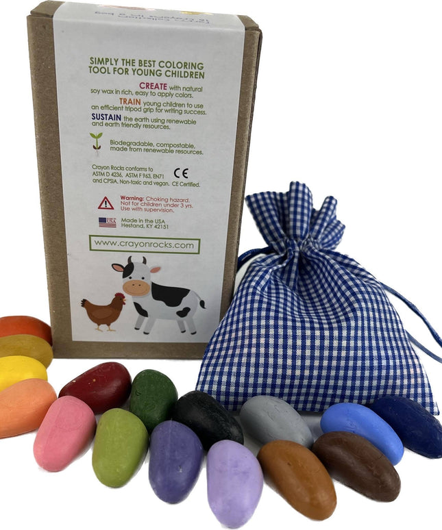 Set of colorful crayon rocks with a branded box and blue checkered bag on a white background