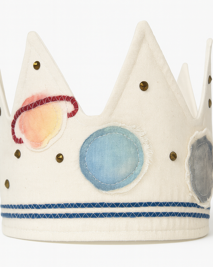 Children's toy crown with colorful planets on a white background