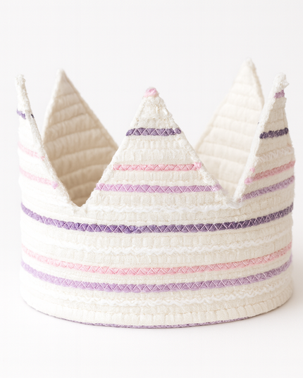 White woven crown with purple and pink stripes on a white background