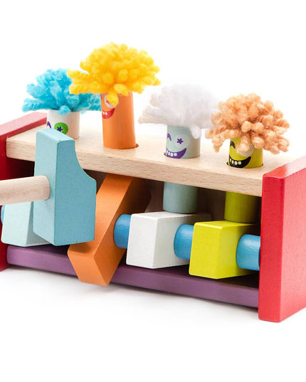 Colorful wooden toy with various shapes and a hammer on a white background
