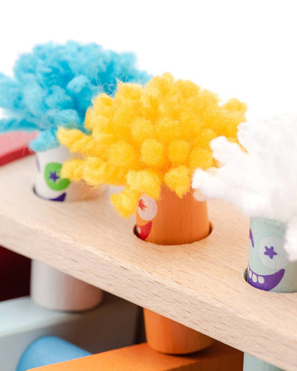 Colorful wooden heads with yarn hair