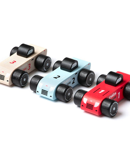 Three toy cars in red, blue, and beige on a white background