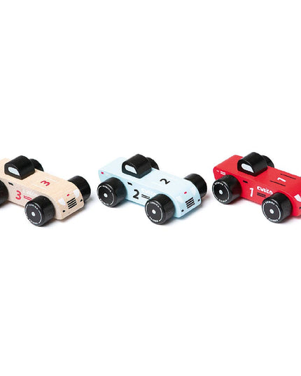 Three wooden toy cars in beige, light blue, and red on a white background