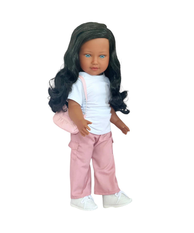 Doll with long dark hair wearing a white shirt and pink pants on a white background