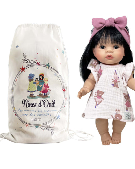 Doll with a pink bow and a branded drawstring bag on a white background