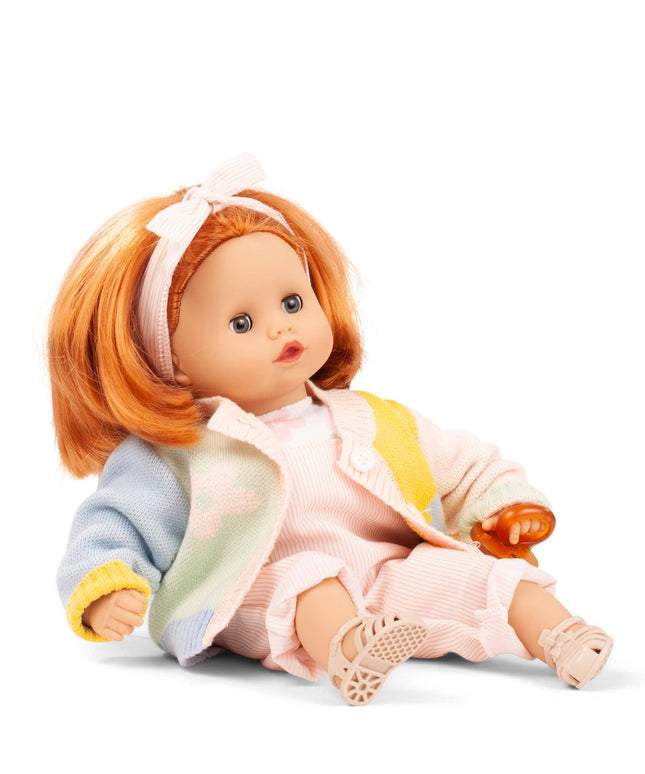 Doll with red hair wearing a colorful outfit on a white background