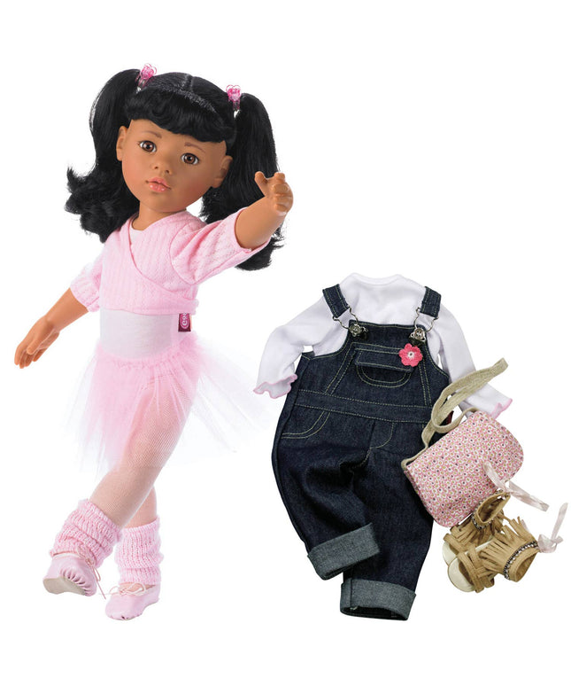 Doll with pink outfit and accessories, including overalls and shoes, on a white background.