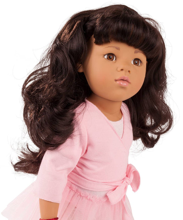 Doll with long dark hair wearing a pink outfit on a white background