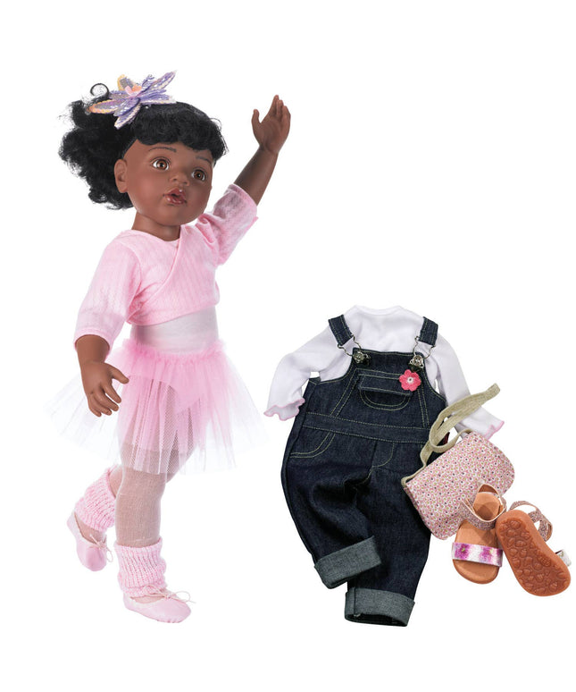 Doll with pink outfit and accessories on a white background