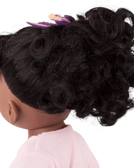 Doll with styled black hair on a white background