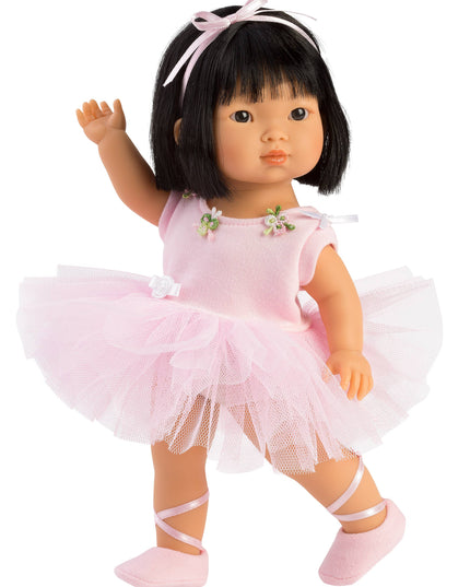 Doll in a pink ballet outfit with a tutu on a white background