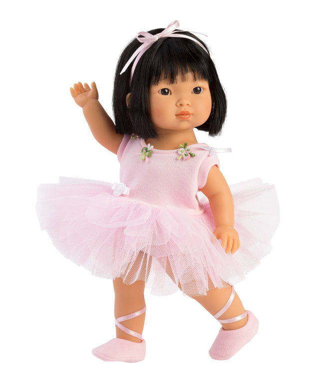Doll in a pink ballet outfit with a tutu on a white background