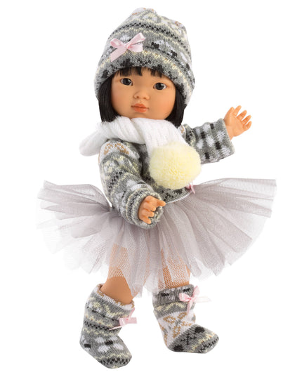 Doll wearing a winter outfit with a hat, scarf, and skirt on a white background