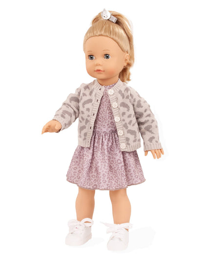 Doll wearing a patterned jacket and dress on a white background