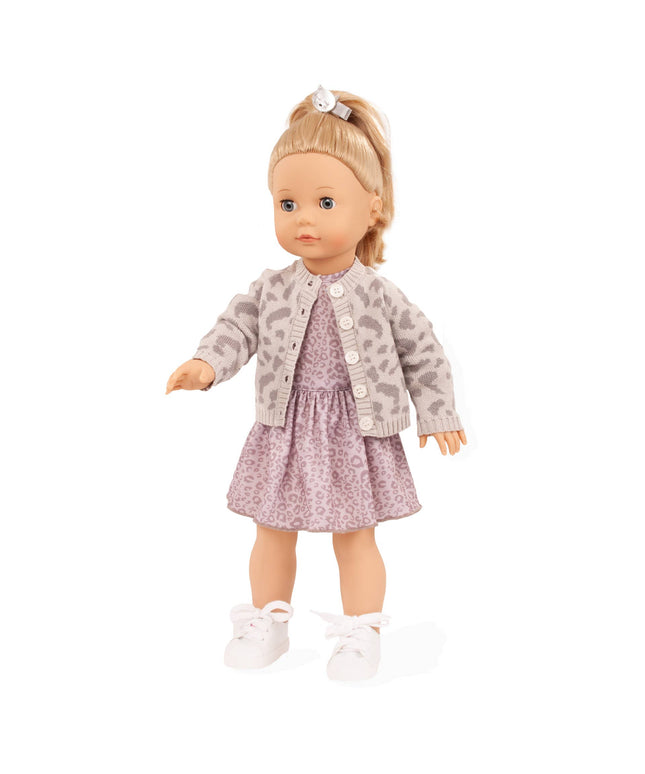 Doll wearing a patterned jacket and dress on a white background